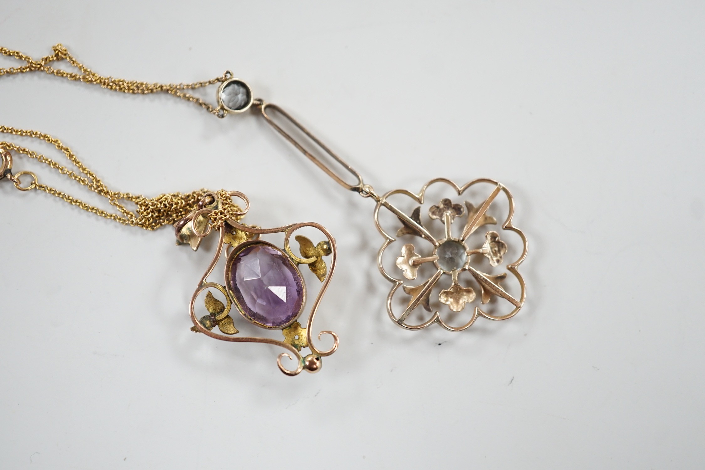 Two Edwardian 9ct and gem set pendants, including amethyst and seed pearl and two stone aquamarine drop, 53mm on a yellow metal chain, gross weight 6.3 grams.